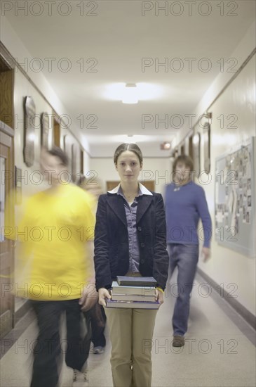 Teenage girl carrying books