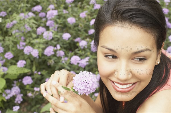 Close up of young woman holding flower