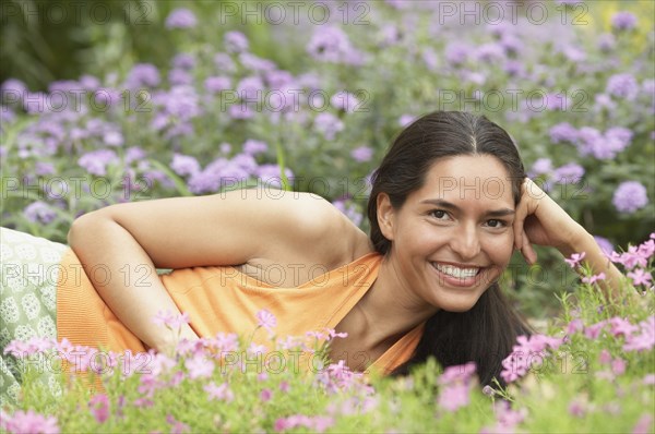 Portrait of young woman lying on grass