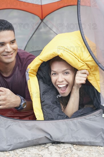 Young couple lying in a tent