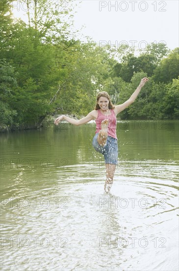 Young woman splashing water