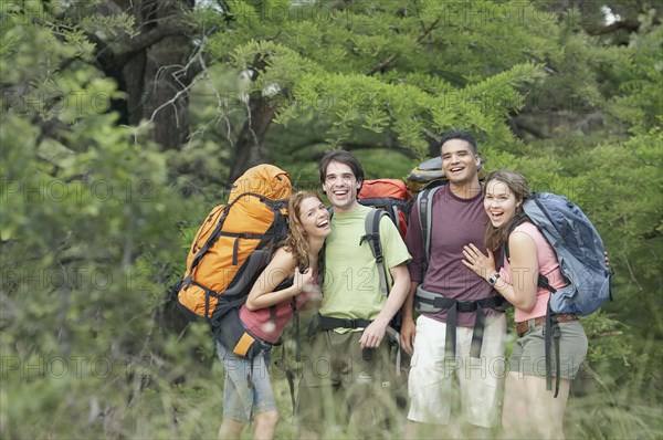 Portrait of two young couples hiking in a forest