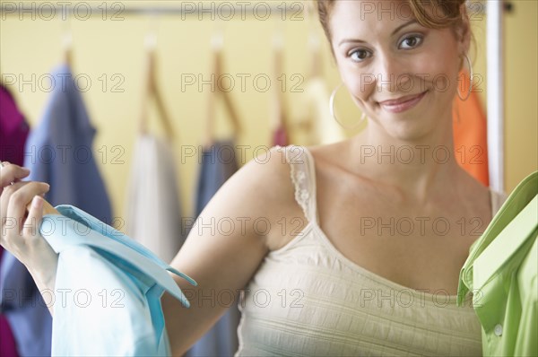 Hispanic women looking at men's clothes in boutique