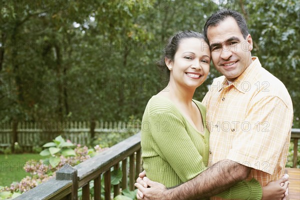 Couple hugging in their backyard