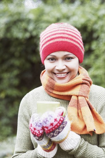 Young woman having a cup of coffee outdoors