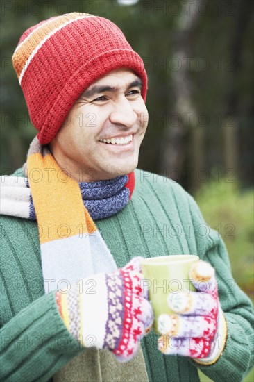 Man having a cup of coffee outdoors