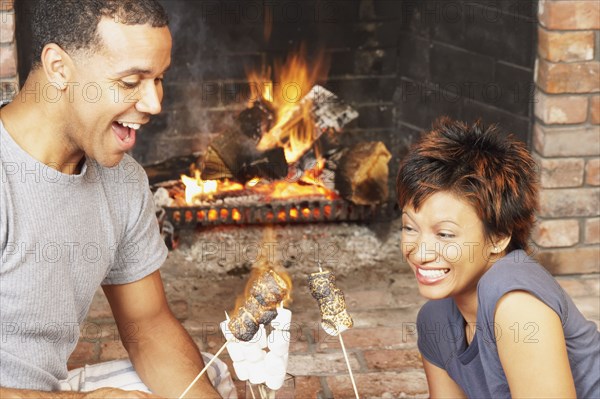 Young couple toasting marshmallows