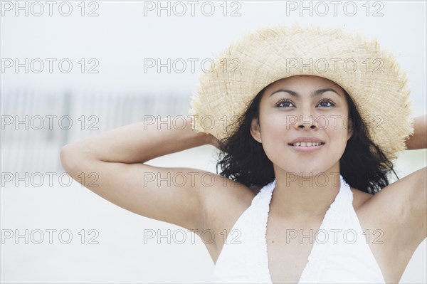 Young woman wearing a straw hat