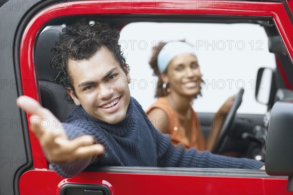 Young man reaching towards the camera for a Jeep