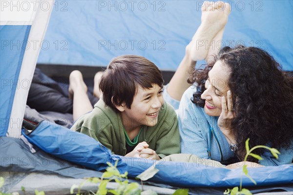 Mother and son laying in tent talking