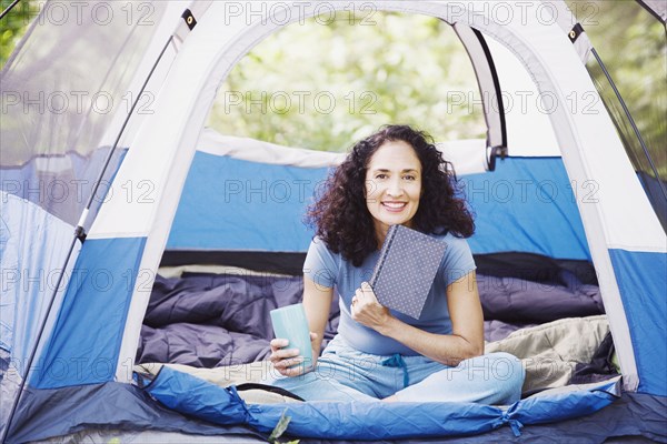 Woman with coffee in tent