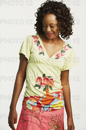 Studio shot of African woman looking down