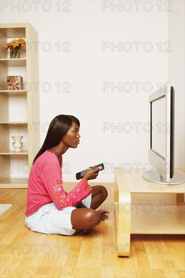 African woman watching television