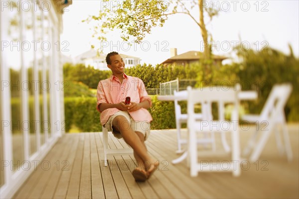 Hispanic man sitting on patio