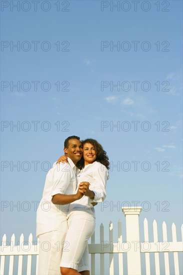 Couple dancing next to fence