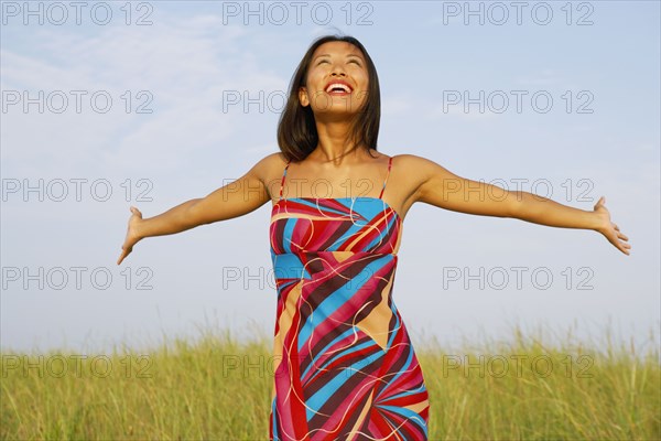 Asian woman with arms outstretched