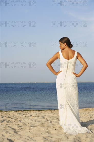 Bride standing on beach