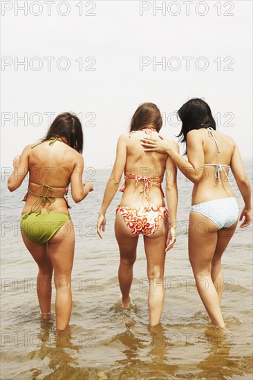 Rear view of three women at beach