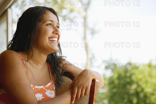 Hispanic woman laughing in chair