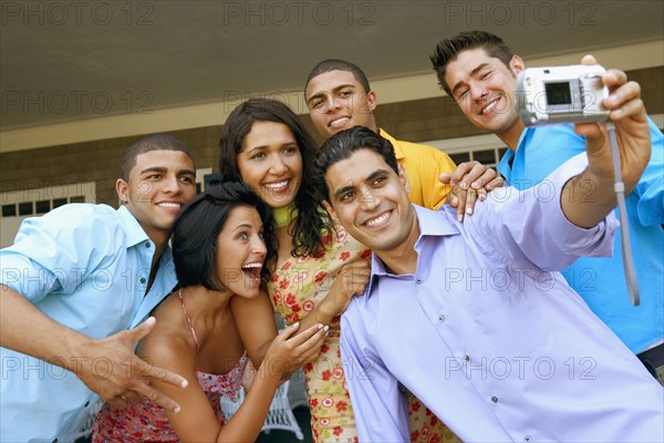 Multi-ethnic friends taking own photograph