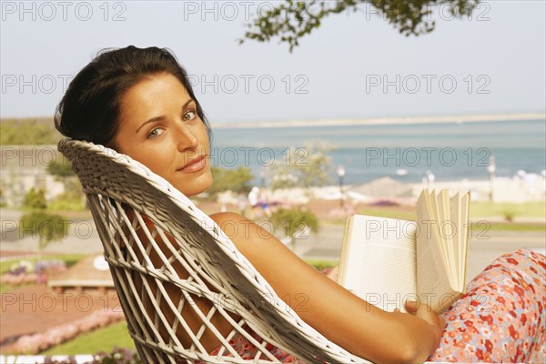 Young woman reading outdoors