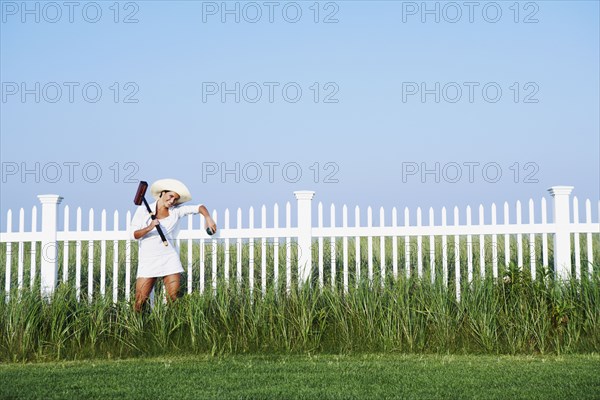 Hispanic woman holding croquet mallet