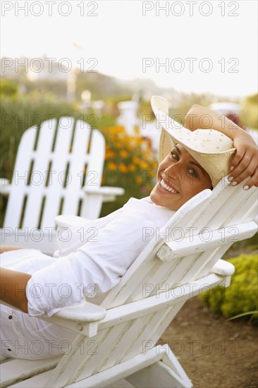 Young woman sitting in deck chair