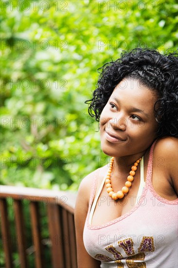 African woman looking pensive on patio