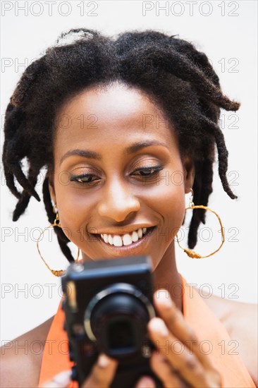 African woman holding digital camera