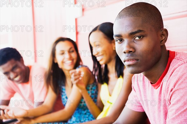 Serious African man with friends in background