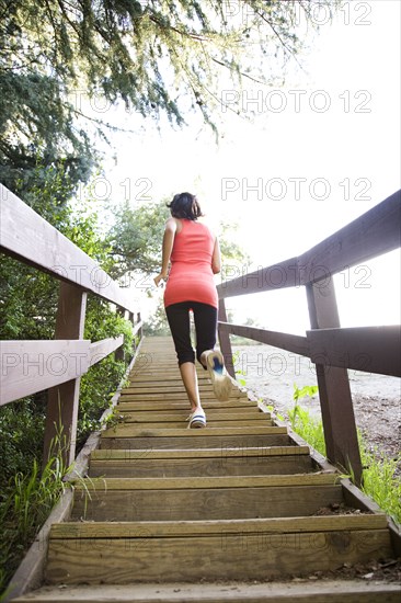 Indian woman running up stairs