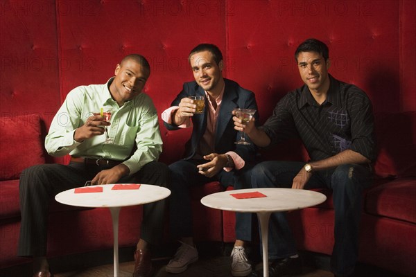 Multi-ethnic men drinking cocktails