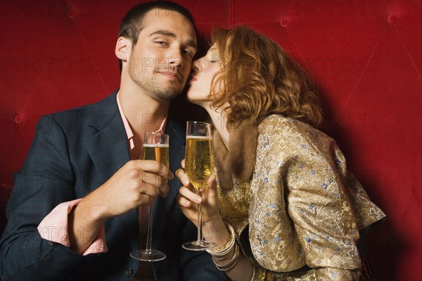 Woman kissing boyfriend's cheek