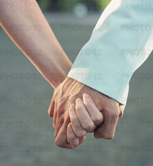 Close up of couple holding hands