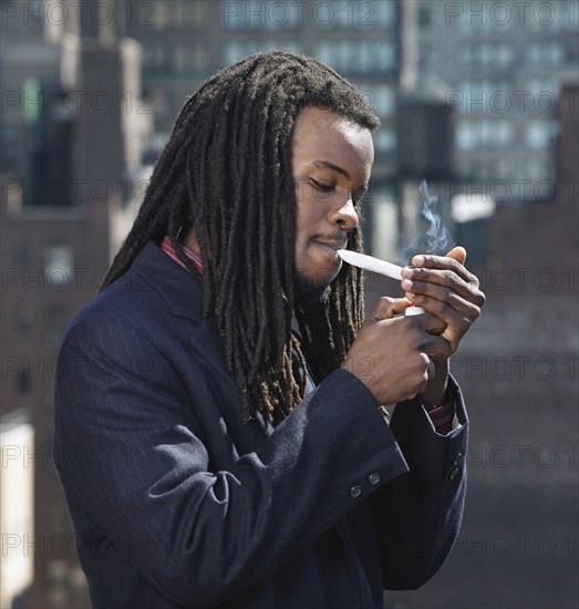 African man smoking hand-rolled cigarette