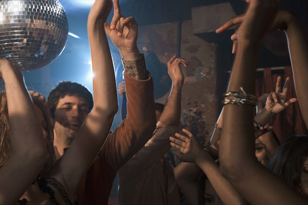 Multi-ethnic people dancing at nightclub