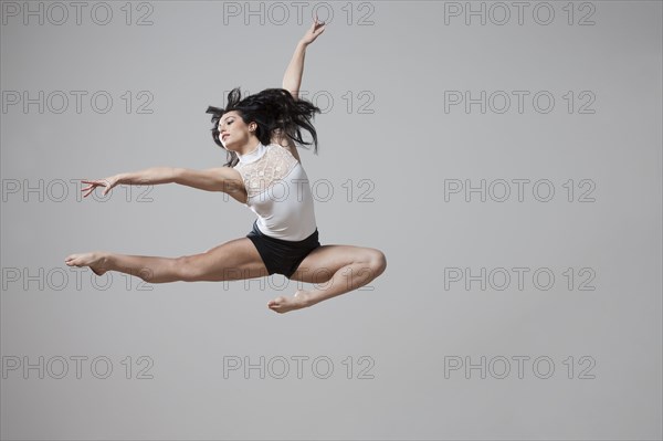 Graceful Caucasian ballet dancer in mid-air