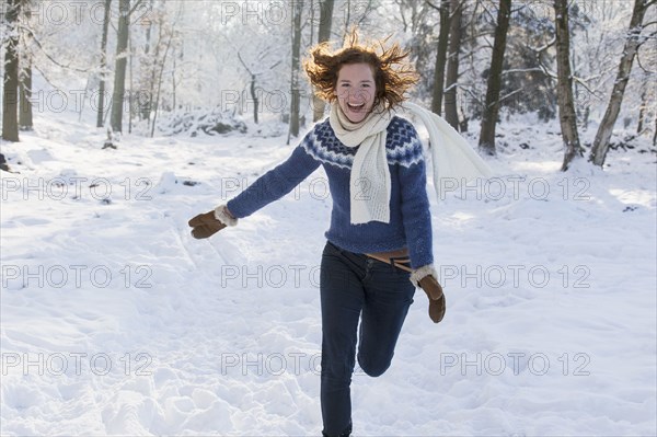 Caucasian woman playing in snow