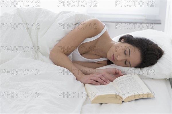 Mixed race woman asleep in bed