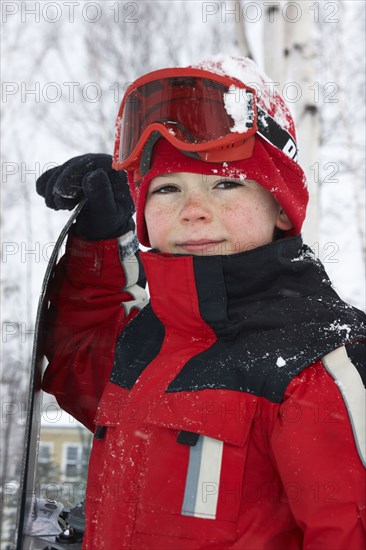 Caucasian boy wearing ski gear in snow