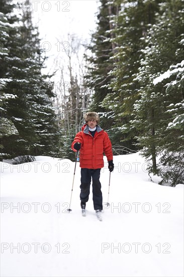 Caucasian man cross country skiing in snowy landscape