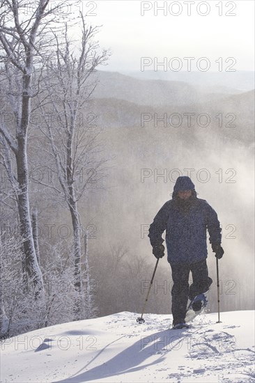 Caucasian man snowshoeing