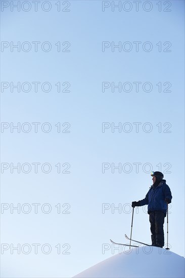 Caucasian skier on hilltop