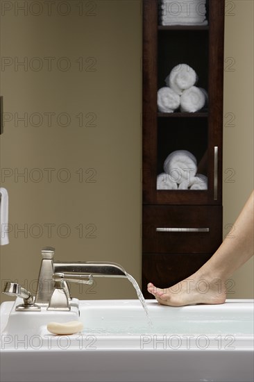 Caucasian woman running bath