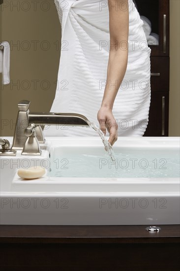 Caucasian woman running bath