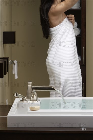 Caucasian woman running bath