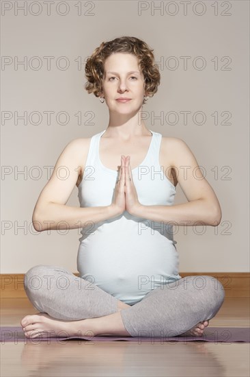 Caucasian pregnant woman meditating