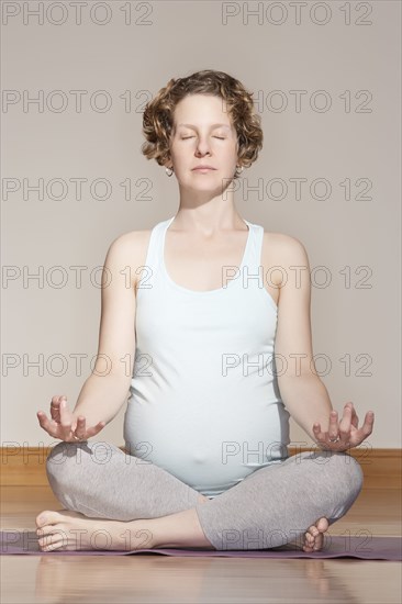 Caucasian pregnant woman meditating