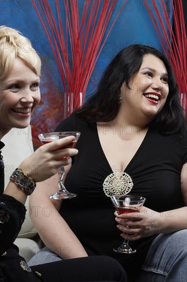 Caucasian women having cocktails together in lounge