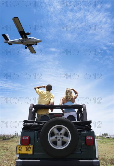 Couple admiring plane from 4x4